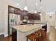 Kitchen featuring granite counters, a large island with seating, and stainless steel appliances at 3623 Pitch Ln, Sarasota, FL 34232
