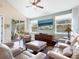 Inviting living room with comfortable seating, a ceiling fan, and sliding door to an outdoor patio at 3623 Pitch Ln, Sarasota, FL 34232