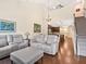 Open-concept living area with hardwood floors, a staircase, and a view of the kitchen at 3623 Pitch Ln, Sarasota, FL 34232