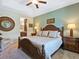 Main bedroom boasting a tray ceiling, carpeted floors, and an attached ensuite bathroom at 3623 Pitch Ln, Sarasota, FL 34232