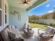 Inviting covered patio with comfortable seating, a ceiling fan, and view of backyard at 3623 Pitch Ln, Sarasota, FL 34232