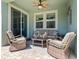 Relaxing outdoor patio with wicker furniture, ceiling fan, and sliding glass door at 3623 Pitch Ln, Sarasota, FL 34232