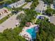 Community aerial view featuring a pool, clubhouse, landscaping and plenty of parking spaces at 3810 N Oak Dr # N61, Tampa, FL 33611