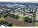 Aerial view showcasing the community, including a pond and the city skyline in the background at 3810 N Oak Dr # N61, Tampa, FL 33611