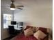 Spacious bedroom with modern ceiling fan and a bright workspace at 3810 N Oak Dr # N61, Tampa, FL 33611