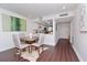 Open concept dining area featuring a round table and chairs, adjacent to the kitchen with modern white cabinets at 3810 N Oak Dr # N61, Tampa, FL 33611