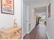 Hallway featuring sleek wood floors, leading to living area with natural light and decor at 3810 N Oak Dr # N61, Tampa, FL 33611