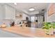 Updated kitchen with stainless appliances, bright lighting, and butcher block countertops at 3810 N Oak Dr # N61, Tampa, FL 33611