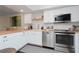Updated kitchen with butcher block counters, white cabinets, stainless appliances, and subway tile backsplash at 3810 N Oak Dr # N61, Tampa, FL 33611