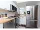 Bright kitchen with stainless steel appliances, subway tile backsplash, and butcher block countertops at 3810 N Oak Dr # N61, Tampa, FL 33611