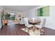 Open-concept living and dining area with modern furnishings, wood floors, and lots of natural light at 3810 N Oak Dr # N61, Tampa, FL 33611