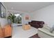 Bright living room with sliding glass doors leading to a patio and backyard views at 3810 N Oak Dr # N61, Tampa, FL 33611