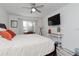 A main bedroom featuring a ceiling fan, television, and sunlit windows for a comfortable retreat at 3810 N Oak Dr # N61, Tampa, FL 33611