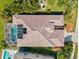 Overhead view of a tile roof, solar panels, screened-in pool, and landscaped yard, enhancing the outdoor experience at 4173 Westbourne Cir, Sarasota, FL 34238