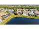 Aerial of homes with screened pools near a tranquil lake, showcasing a peaceful residential setting at 4173 Westbourne Cir, Sarasota, FL 34238