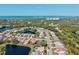 Scenic aerial view of a waterfront community, showcasing lovely homes, lush trees, and stunning views of the ocean at 4173 Westbourne Cir, Sarasota, FL 34238
