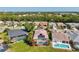 An aerial shot of homes with screened-in pools and well-maintained lawns, surrounded by lush greenery at 4173 Westbourne Cir, Sarasota, FL 34238