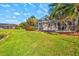 A well-manicured backyard boasts a pool, a lake view, and lush green grass at 4173 Westbourne Cir, Sarasota, FL 34238
