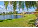 Beautifully landscaped backyard featuring green grass and gorgeous lake views at 4173 Westbourne Cir, Sarasota, FL 34238