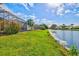 Stunning lawn, lush landscaping, and tranquil lake views enhance the curb appeal at 4173 Westbourne Cir, Sarasota, FL 34238