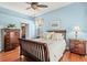This bedroom features hard wood floors, a ceiling fan, and soft natural light at 4173 Westbourne Cir, Sarasota, FL 34238