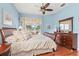 A bedroom featuring hard wood floors, a ceiling fan, and soft natural light at 4173 Westbourne Cir, Sarasota, FL 34238
