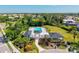 Community pool aerial view, showcasing lush landscaping and elegant entrance, providing a perfect place to relax and enjoy the outdoors at 4173 Westbourne Cir, Sarasota, FL 34238