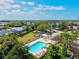 Aerial view showcasing a community pool surrounded by trees and residential properties, offering an oasis for relaxation and recreation at 4173 Westbourne Cir, Sarasota, FL 34238