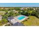 Aerial view of the community pool featuring an inviting pool, comfortable lounge chairs, and lush trees for a relaxing experience at 4173 Westbourne Cir, Sarasota, FL 34238