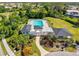Community pool aerial view with a view of seating around the pool, lush landscaping and elegant entrance for relaxation and enjoyment at 4173 Westbourne Cir, Sarasota, FL 34238