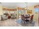 Dining area with seating for six next to bright sitting area at 4173 Westbourne Cir, Sarasota, FL 34238