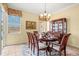 Formal dining room with chandelier and cabinet for storage at 4173 Westbourne Cir, Sarasota, FL 34238