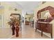 Elegant entryway featuring decorative mirror, console table, and view into the spacious living area at 4173 Westbourne Cir, Sarasota, FL 34238