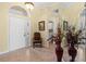 Inviting foyer with a chair, decorative mirror, and tile flooring at 4173 Westbourne Cir, Sarasota, FL 34238