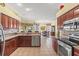 Open-concept kitchen with stainless steel appliances and warm wood cabinetry at 4173 Westbourne Cir, Sarasota, FL 34238