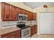 Kitchen area with stainless steel appliances and ample wood cabinet storage at 4173 Westbourne Cir, Sarasota, FL 34238