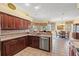 Kitchen with granite counters and stainless steel appliances open to the dining room at 4173 Westbourne Cir, Sarasota, FL 34238