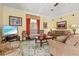 Cozy living room with sofas, floral rug, and a television for entertainment at 4173 Westbourne Cir, Sarasota, FL 34238