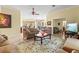 Open-concept living room with a floral rug, comfortable seating, and views of the dining area at 4173 Westbourne Cir, Sarasota, FL 34238