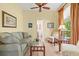 Bright living room with tile flooring, ceiling fan, and view to bathroom at 4173 Westbourne Cir, Sarasota, FL 34238