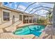 A beautiful pool with screen enclosure and brick pavers sits outside the home at 4173 Westbourne Cir, Sarasota, FL 34238