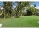 Expansive back yard featuring mature trees and lush landscaping providing a serene outdoor space at 4211 73Rd E Ter, Sarasota, FL 34243