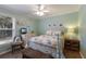 Comfortable bedroom featuring a seaside theme, ceiling fan, seaside themed linens and decorative mirror at 4211 73Rd E Ter, Sarasota, FL 34243