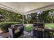Outdoor patio with a grill, green lawn, and lush trees at 4211 73Rd E Ter, Sarasota, FL 34243