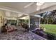 Covered patio with comfortable seating and a view of the beautifully landscaped backyard at 4211 73Rd E Ter, Sarasota, FL 34243