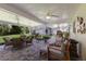 Large covered patio area with ceiling fans, ample seating, and outdoor kitchen, perfect for entertaining at 4211 73Rd E Ter, Sarasota, FL 34243