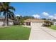 Charming single-Gathering home featuring a manicured lawn and a spacious two-car garage at 4211 73Rd E Ter, Sarasota, FL 34243