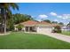 Charming single-story home with a well-manicured lawn, two-car garage, and inviting front entrance at 4211 73Rd E Ter, Sarasota, FL 34243