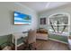 Bright home office space with a large window, modern desk, and beach scene on the television at 4211 73Rd E Ter, Sarasota, FL 34243