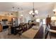Open-concept kitchen and dining area, features granite counters, stainless appliances, and flows to the living area at 4211 73Rd E Ter, Sarasota, FL 34243